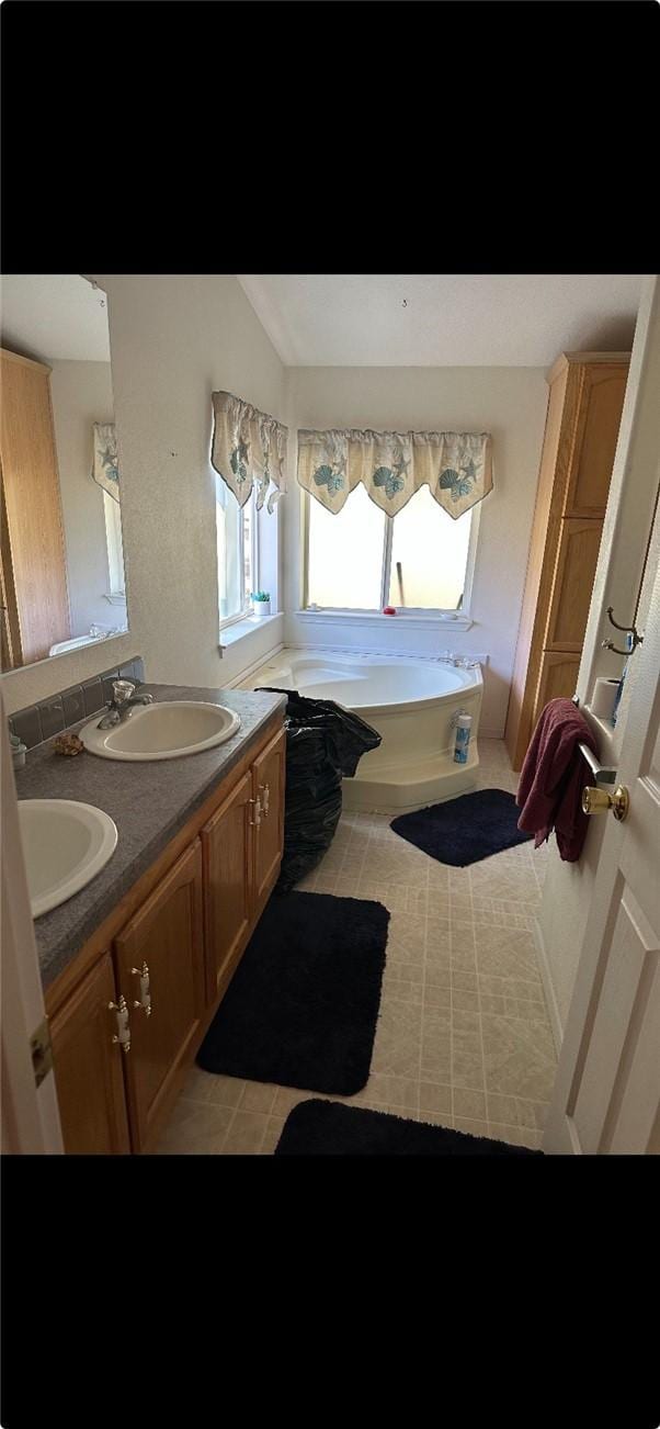6117 Juniper Rd, Lake Isabella, CA 93240 - full bath with double vanity, a garden tub, and tile patterned floors