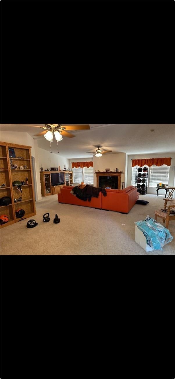 carpeted living area featuring a fireplace