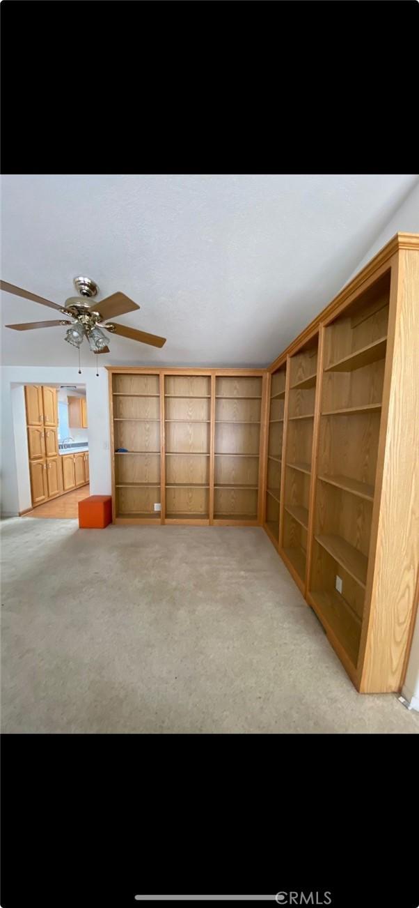 6117 Juniper Rd, Lake Isabella, CA 93240 - unfurnished living room with light colored carpet and a ceiling fan