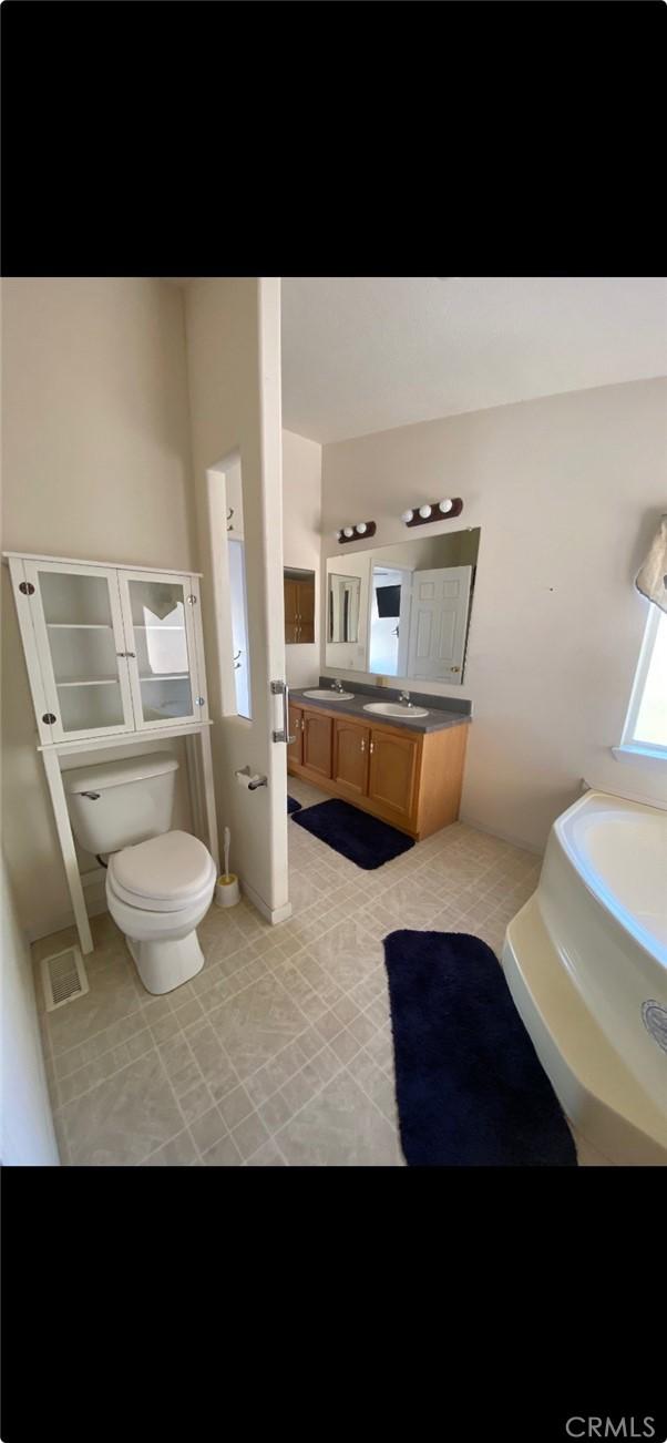 6117 Juniper Rd, Lake Isabella, CA 93240 - full bath featuring vanity, a garden tub, and tile patterned floors