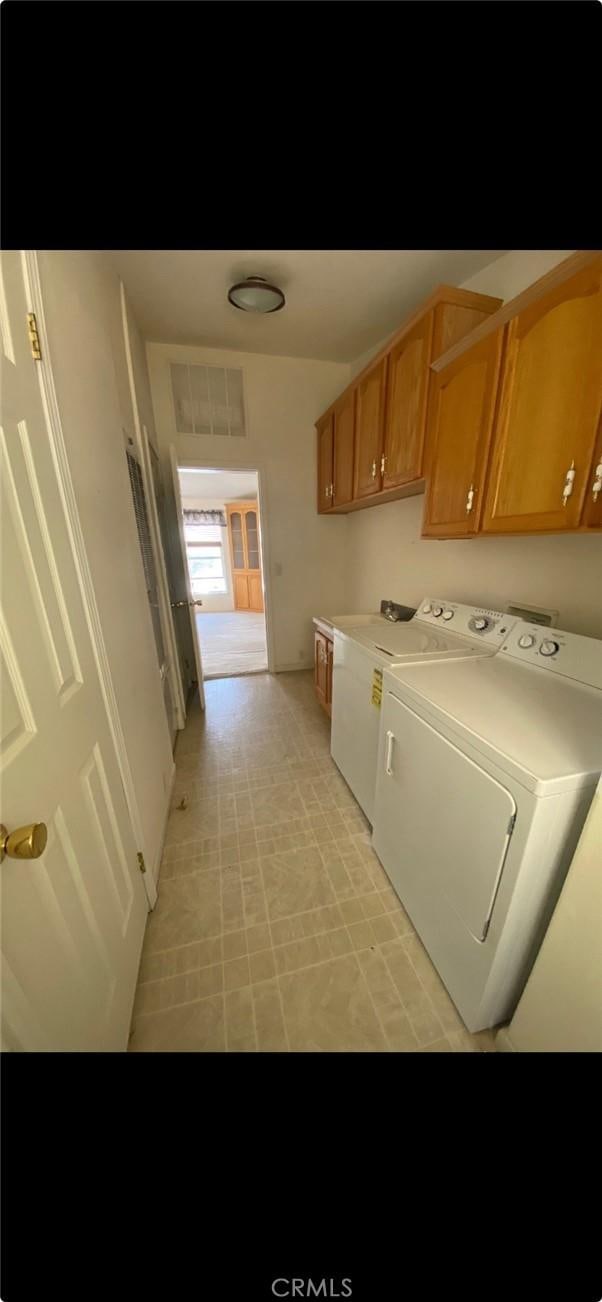 6117 Juniper Rd, Lake Isabella, CA 93240 - laundry room with cabinet space, washer and clothes dryer, and light floors