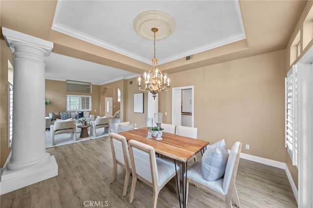 24240 Avenida De Marcia, Yorba Linda, CA 92887 - dining area with a tray ceiling, wood finished floors, a chandelier, ornate columns, and crown molding
