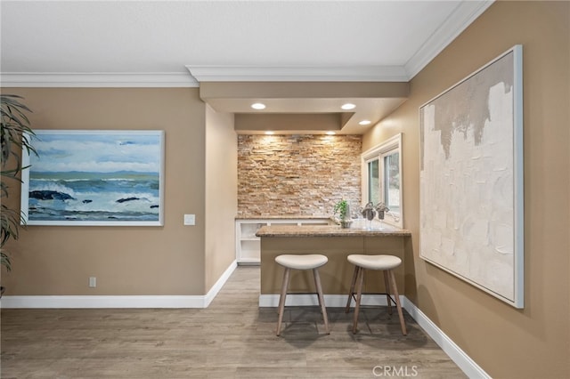 interior space with crown molding, baseboards, and wood finished floors