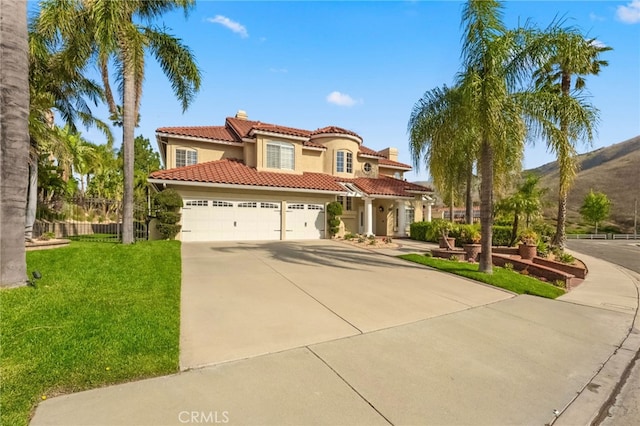 24240 Avenida De Marcia, Yorba Linda, CA 92887 - mediterranean / spanish-style home with stucco siding, driveway, a tiled roof, a garage, and a chimney