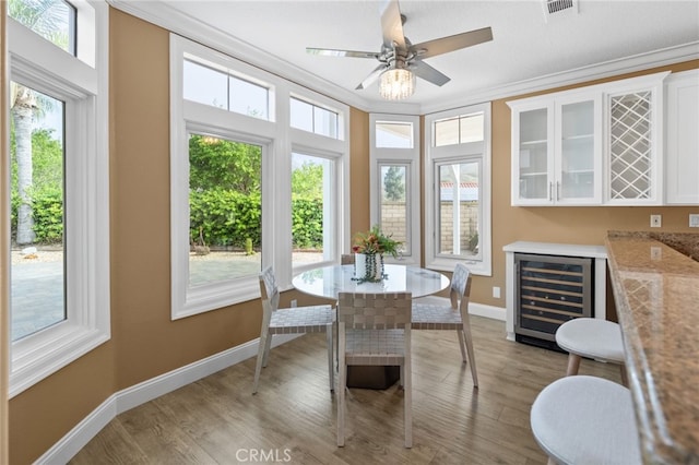 sunroom / solarium with visible vents and wine cooler