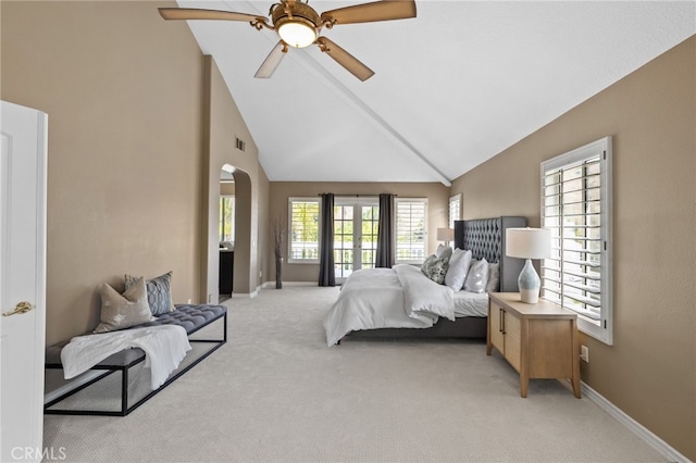 bedroom with light carpet, baseboards, and arched walkways
