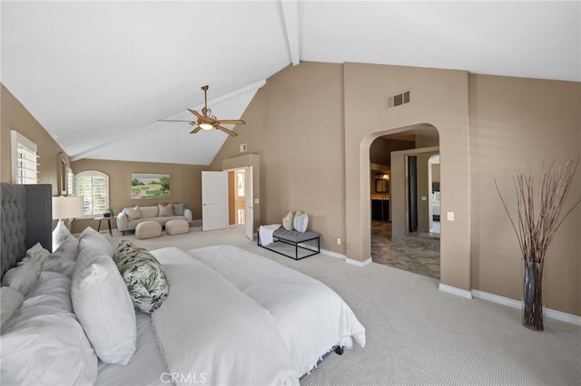 bedroom featuring visible vents, beamed ceiling, high vaulted ceiling, arched walkways, and light colored carpet