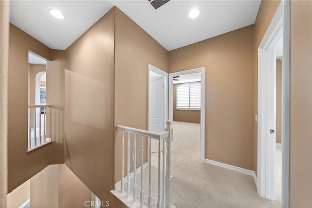 hall with baseboards, recessed lighting, an upstairs landing, carpet floors, and visible vents