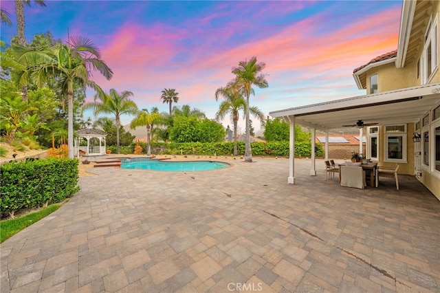 24240 Avenida De Marcia, Yorba Linda, CA 92887 - pool at dusk featuring a gazebo, a ceiling fan, an outdoor pool, a patio, and outdoor dining space