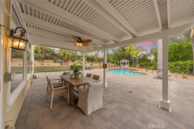 view of patio / terrace featuring an outdoor pool, a ceiling fan, and outdoor dining area
