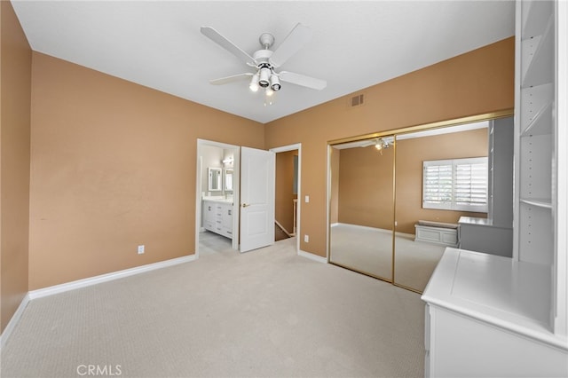 unfurnished bedroom featuring a closet, baseboards, and light carpet