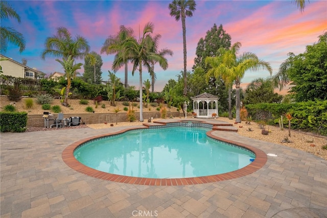 outdoor pool with a patio and a gazebo