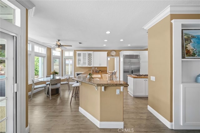 24240 Avenida De Marcia, Yorba Linda, CA 92887 - kitchen featuring stainless steel built in refrigerator, crown molding, a breakfast bar, white cabinetry, and a ceiling fan