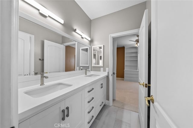 full bathroom with double vanity, a sink, and ceiling fan