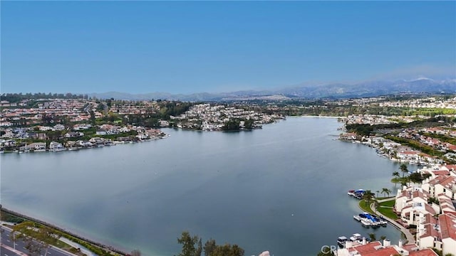 birds eye view of property with a water and mountain view