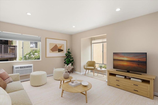 carpeted living room with plenty of natural light, baseboards, recessed lighting, and a wall mounted air conditioner