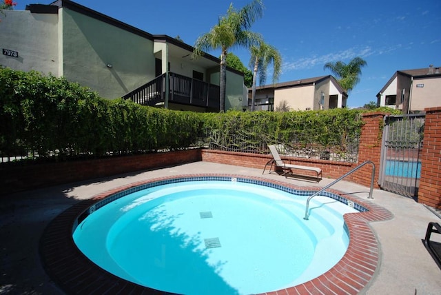 view of swimming pool with a swimming pool and fence