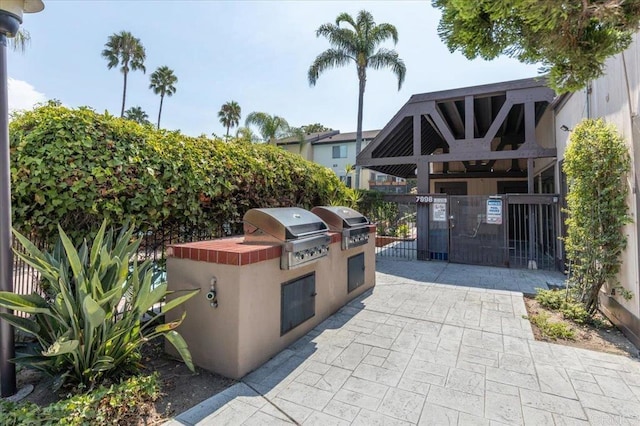 7960 Mission Center Ct Unit F, San Diego, CA 92108 - view of patio / terrace with exterior kitchen and a gate