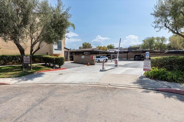 7960 Mission Center Ct Unit F, San Diego, CA 92108 - view of property hidden behind natural elements with covered and uncovered parking and stucco siding