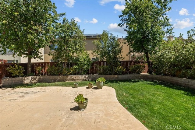 view of yard with fence and a patio