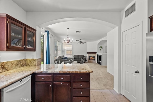 kitchen featuring an inviting chandelier, arched walkways, dishwasher, and visible vents