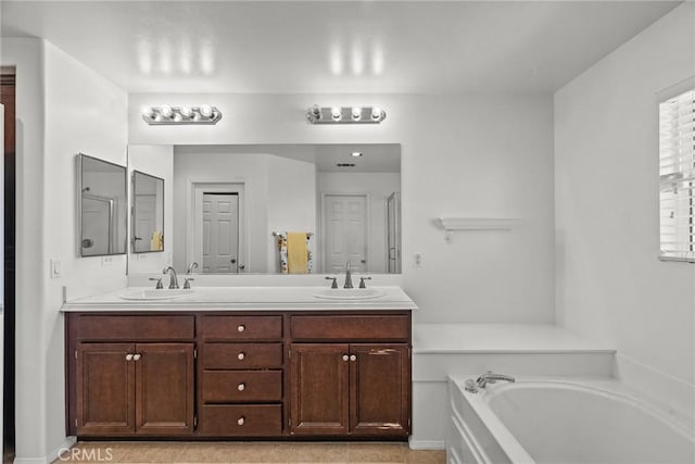 bathroom featuring double vanity, a bath, and a sink