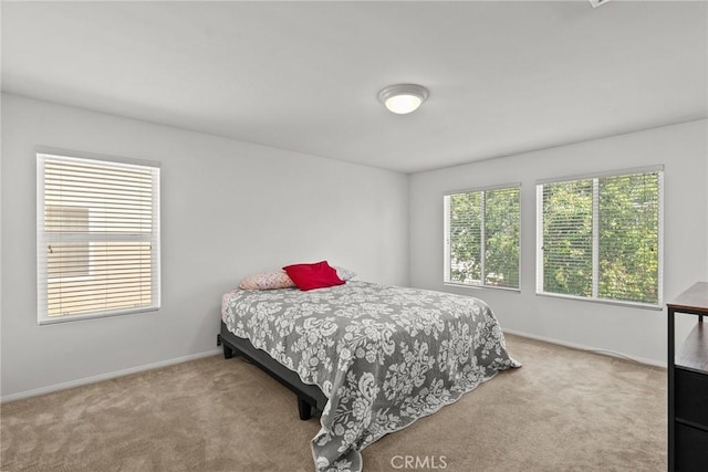 bedroom with baseboards and carpet flooring