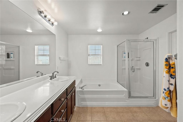 full bath with a shower stall, a sink, visible vents, and a wealth of natural light