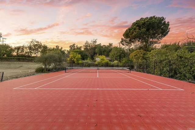 view of tennis court with fence and community basketball court