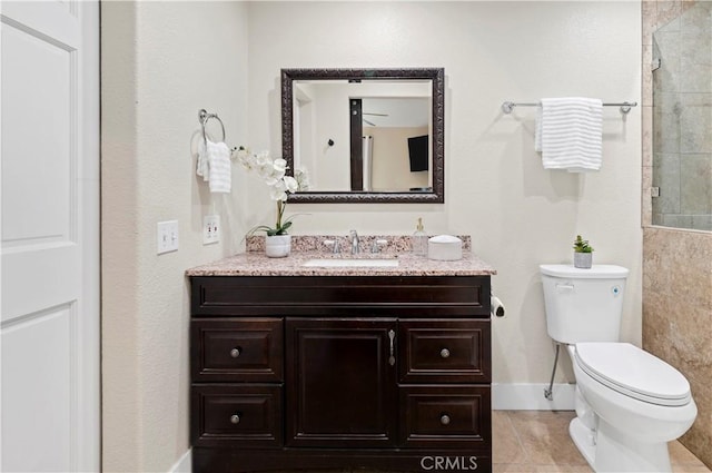 full bath with toilet, tile patterned floors, vanity, baseboards, and tiled shower