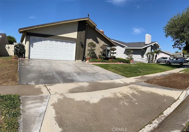 view of front of property with a garage, driveway, and a front yard