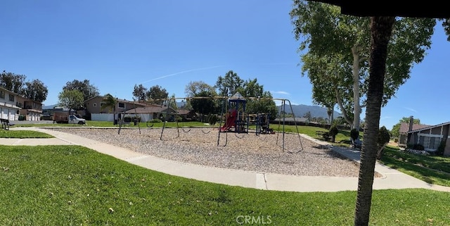 community play area with a lawn and a residential view
