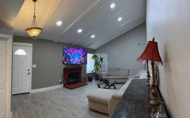 living area featuring a brick fireplace, recessed lighting, baseboards, wood finished floors, and vaulted ceiling