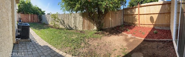 view of yard with a fenced backyard and cooling unit