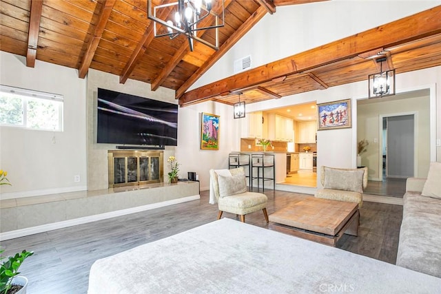 10444 Flowerdale Ct, Sun Valley, CA 91352 - living area with wood finished floors, an inviting chandelier, beamed ceiling, and wooden ceiling