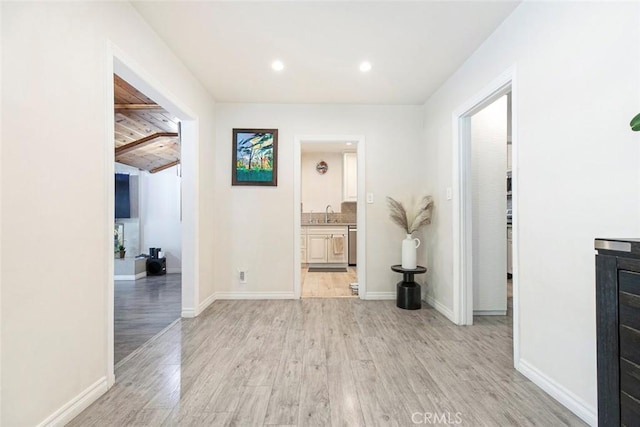 10444 Flowerdale Ct, Sun Valley, CA 91352 - hallway featuring recessed lighting, light wood-style floors, baseboards, and a sink