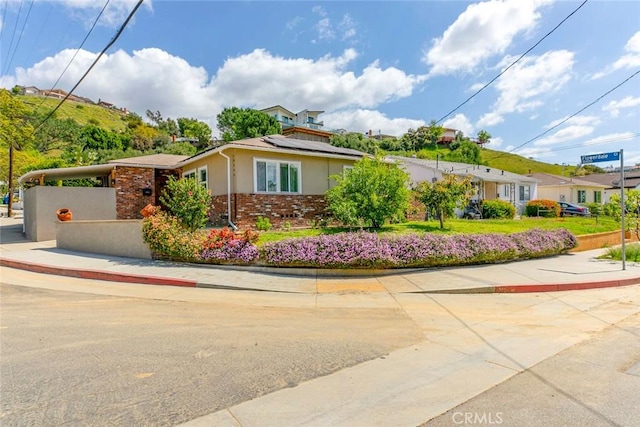 10444 Flowerdale Ct, Sun Valley, CA 91352 - view of front of home with stucco siding, solar panels, and brick siding