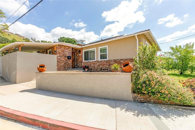 10444 Flowerdale Ct, Sun Valley, CA 91352 - mid-century inspired home featuring a fenced front yard, stucco siding, and brick siding