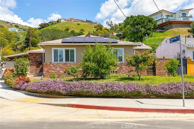10444 Flowerdale Ct, Sun Valley, CA 91352 - view of side of property with brick siding, fence, stucco siding, and roof mounted solar panels