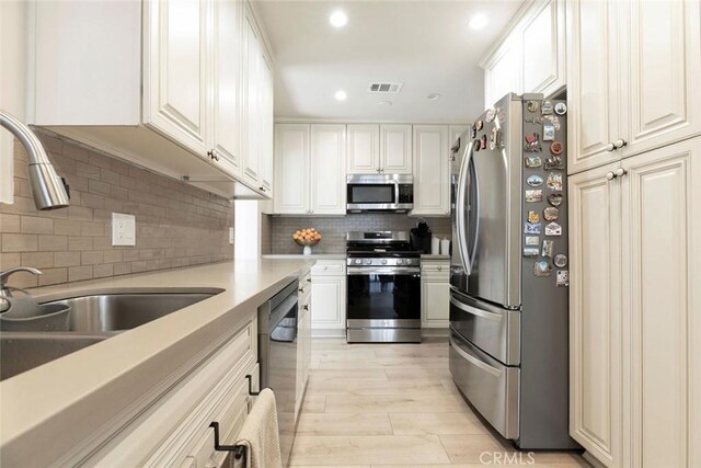 10444 Flowerdale Ct, Sun Valley, CA 91352 - kitchen featuring appliances with stainless steel finishes, decorative backsplash, light countertops, and recessed lighting
