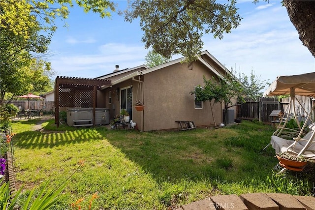 11 Maddie Ct, Chico, CA 95973 - rear view of property featuring a pergola, a hot tub, a yard, a fenced backyard, and stucco siding
