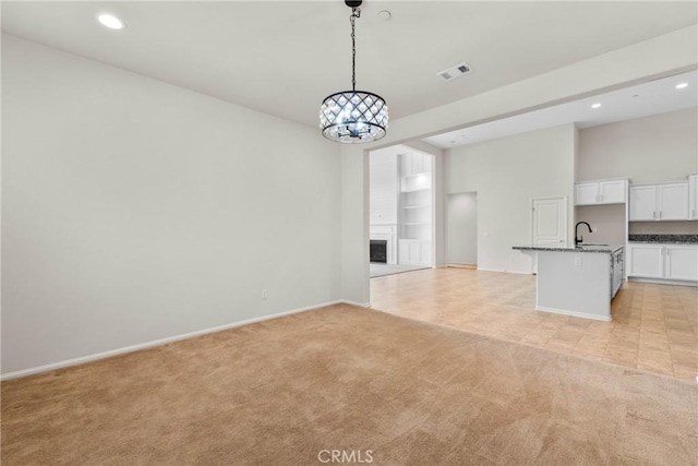 unfurnished living room with light colored carpet, baseboards, visible vents, and recessed lighting