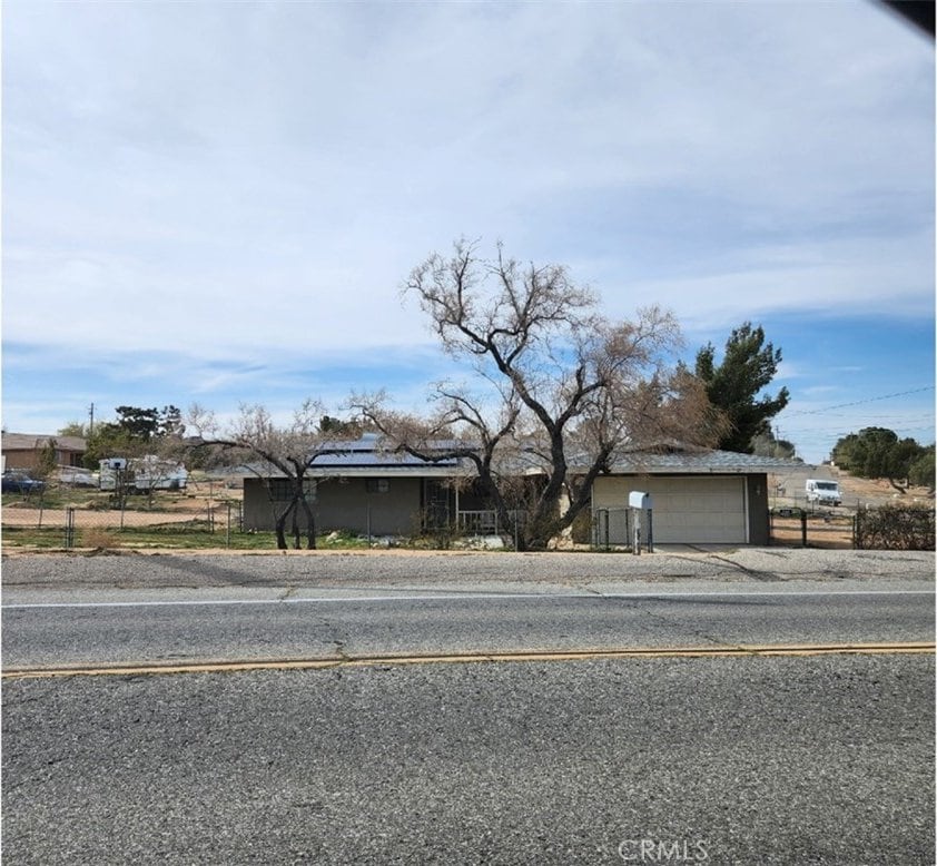 18626 Ranchero Rd, Hesperia, CA 92345 - view of front of house featuring roof mounted solar panels and fence