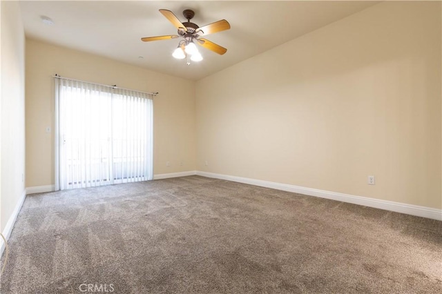 spare room with carpet, baseboards, lofted ceiling, and ceiling fan