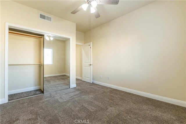 unfurnished bedroom with visible vents, a closet, baseboards, ceiling fan, and carpet
