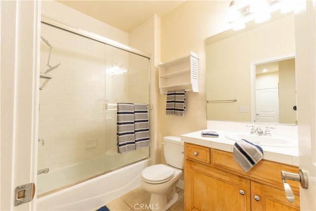 bathroom with enclosed tub / shower combo, vanity, and toilet