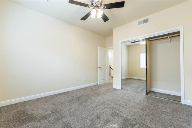 unfurnished bedroom featuring visible vents, baseboards, a closet, a ceiling fan, and carpet floors