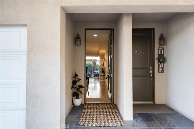 property entrance featuring stucco siding