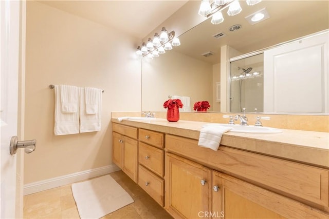 bathroom with visible vents, baseboards, a sink, double vanity, and a stall shower