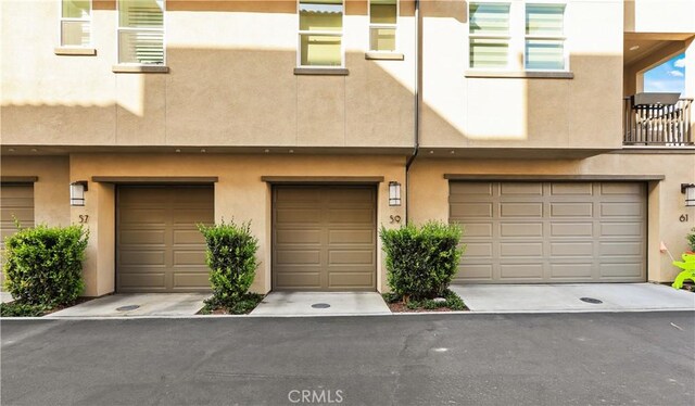 59 Sanctuary Ln, Mission Viejo, CA 92692 - view of front of property with an attached garage and stucco siding